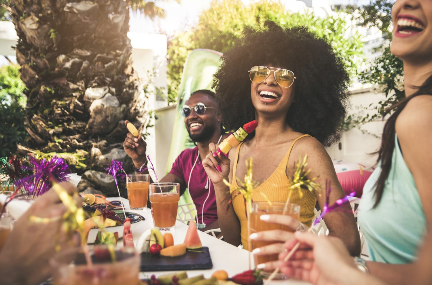 Happy woman smiling at the camera having fun with friends outdoor at the restaurant